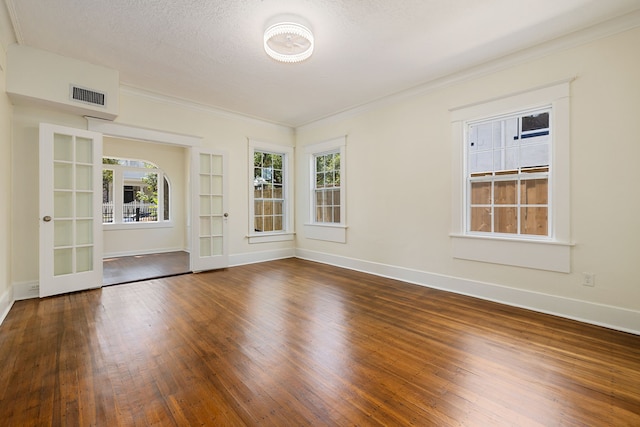 empty room with visible vents, baseboards, and hardwood / wood-style floors