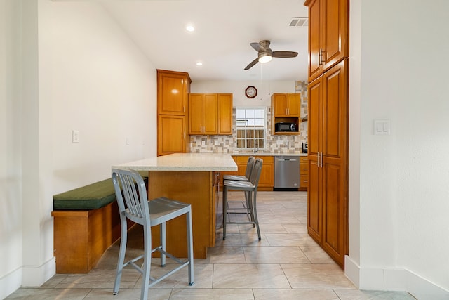kitchen featuring light countertops, dishwasher, ceiling fan, and black microwave
