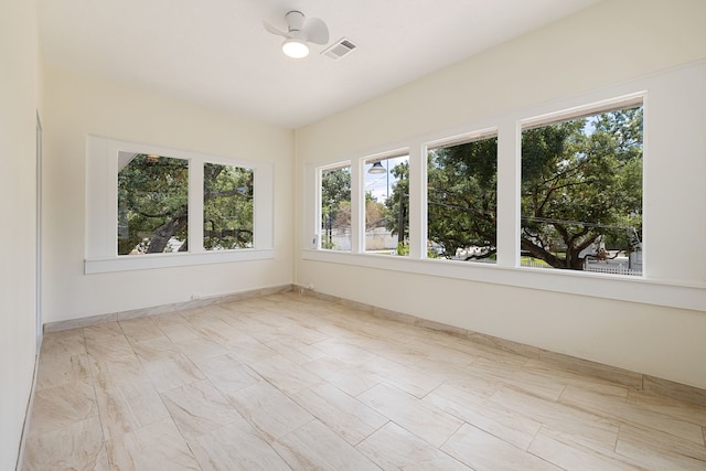 spare room with visible vents, baseboards, and a healthy amount of sunlight