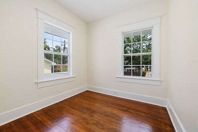 unfurnished room with hardwood / wood-style flooring and plenty of natural light