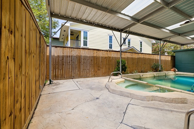 view of swimming pool featuring a fenced backyard, an in ground hot tub, and a patio area