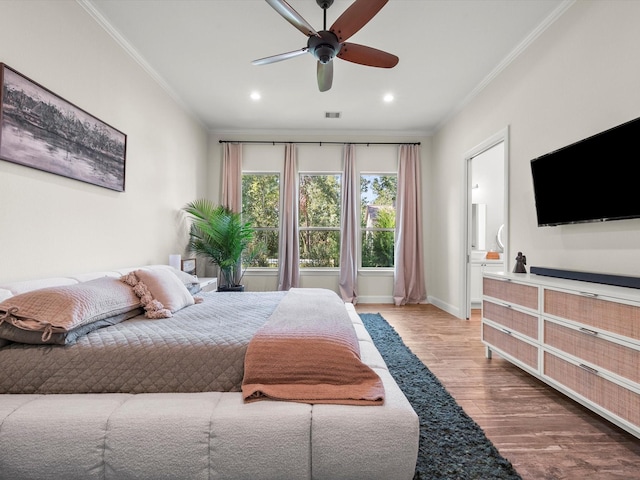 bedroom with baseboards, recessed lighting, wood finished floors, and crown molding