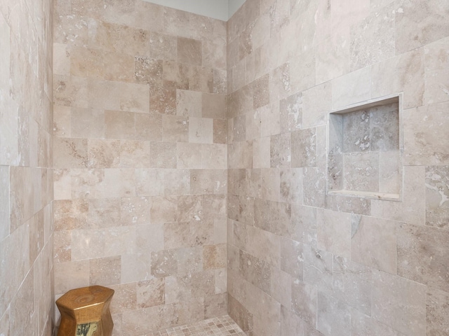 bathroom with tiled shower