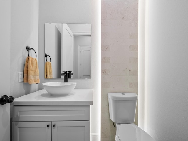 bathroom featuring toilet and vanity