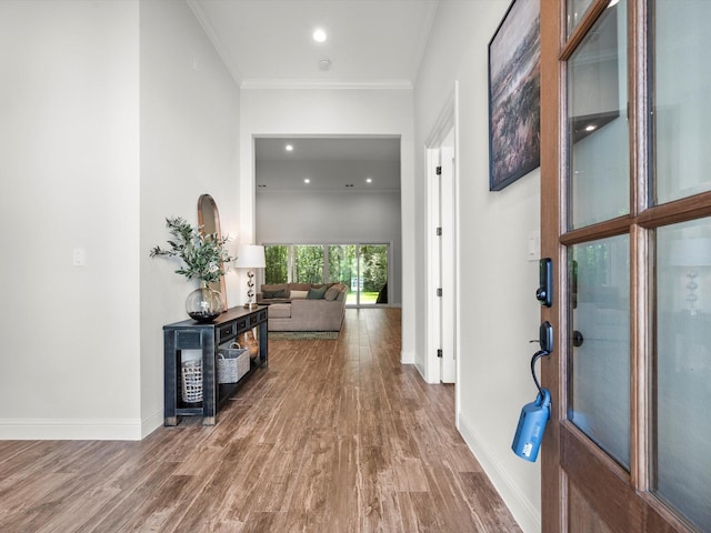 hall featuring ornamental molding, recessed lighting, wood finished floors, and baseboards