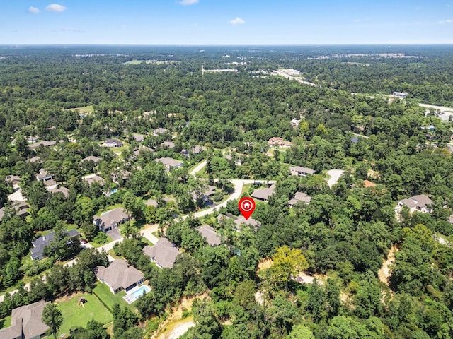 birds eye view of property with a forest view