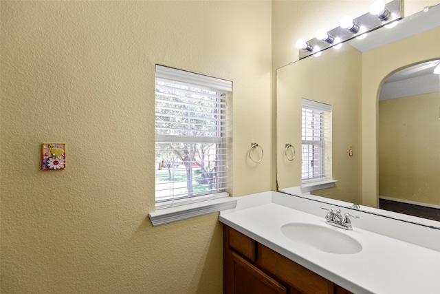 bathroom featuring plenty of natural light and vanity