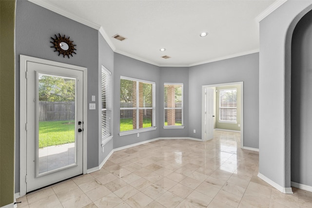 entryway featuring plenty of natural light, crown molding, and light tile patterned floors