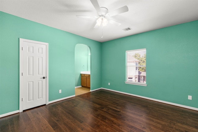 empty room featuring ceiling fan and dark wood-type flooring