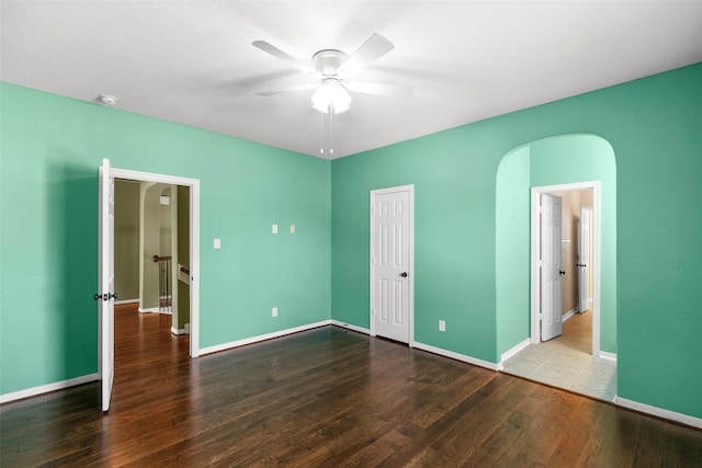 empty room featuring ceiling fan and hardwood / wood-style flooring