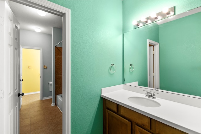 bathroom featuring tile patterned floors, shower / bath combination, and vanity