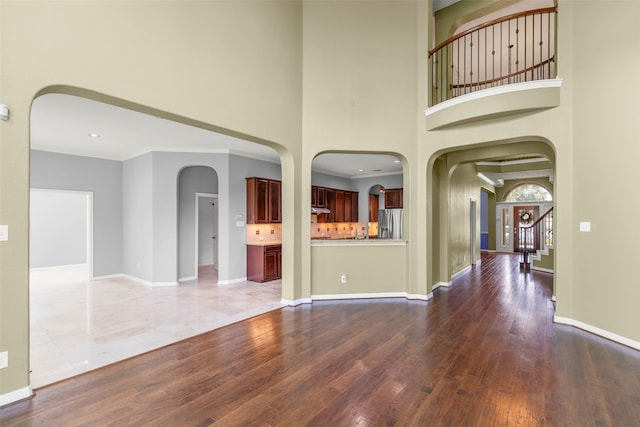 interior space featuring a towering ceiling and tile patterned floors