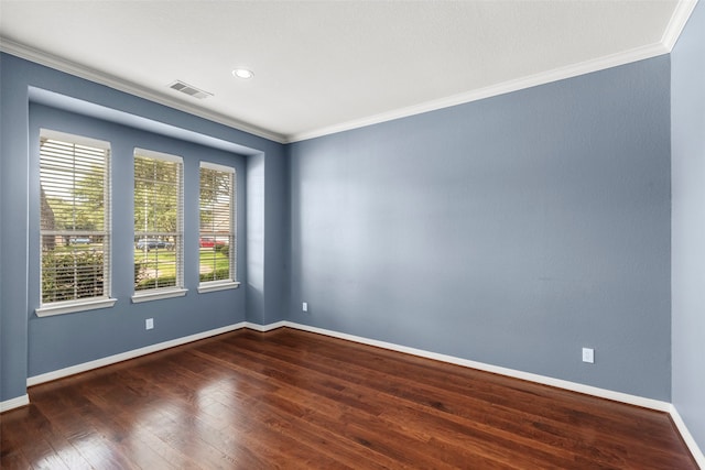 empty room with ornamental molding and wood-type flooring