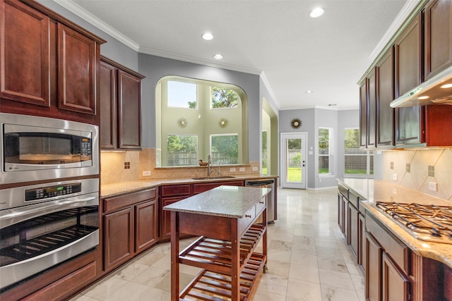 kitchen with light tile patterned floors, backsplash, stainless steel appliances, and light stone counters