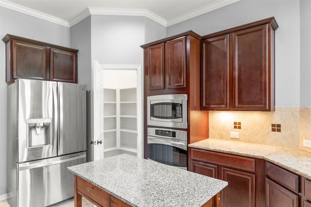 kitchen featuring appliances with stainless steel finishes, light stone countertops, crown molding, and tasteful backsplash