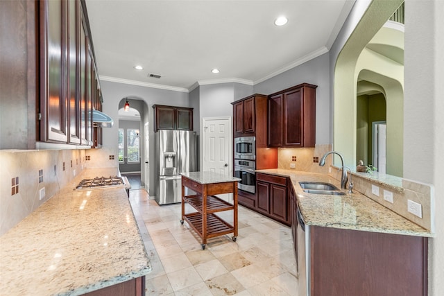 kitchen featuring sink, tasteful backsplash, light stone countertops, and stainless steel appliances