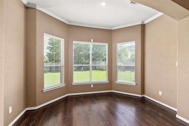 unfurnished room featuring a healthy amount of sunlight, ornamental molding, and wood-type flooring