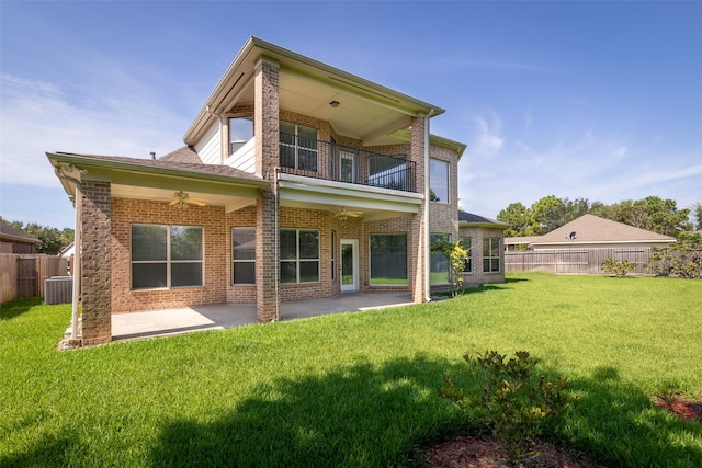 rear view of house featuring ceiling fan, central AC, a patio area, and a lawn