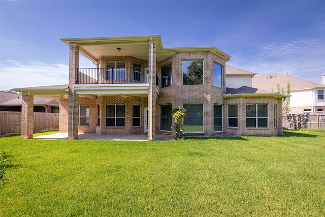 back of house with a patio, a balcony, and a lawn