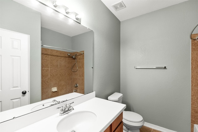 full bathroom featuring toilet, tiled shower / bath combo, and vanity