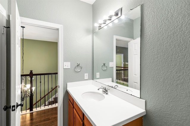 bathroom with hardwood / wood-style flooring and vanity