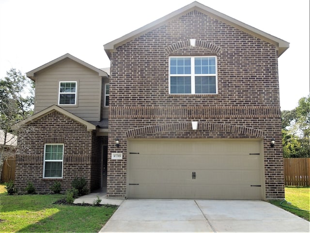 front of property featuring a front yard and a garage