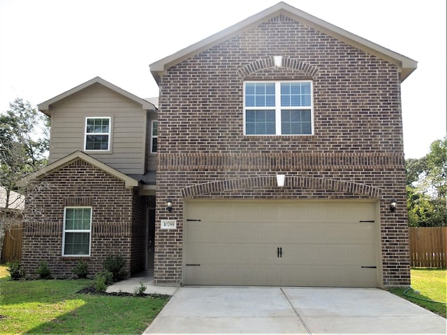 traditional-style house with an attached garage, fence, concrete driveway, and brick siding