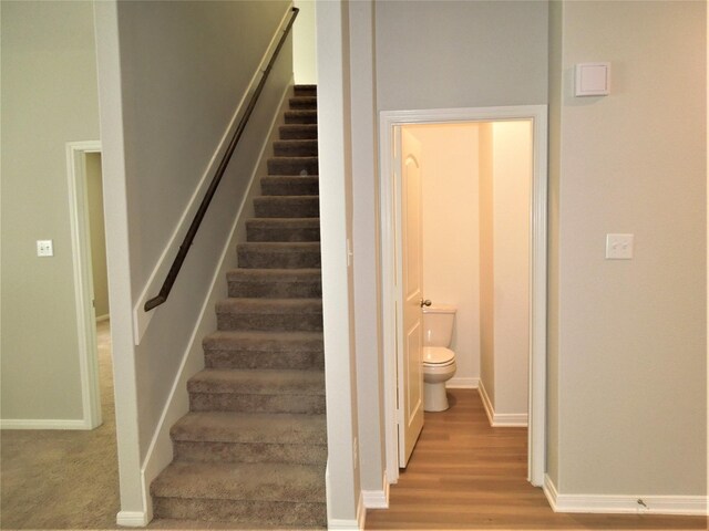 staircase featuring hardwood / wood-style flooring