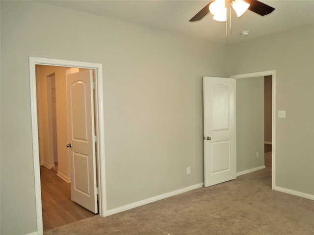 unfurnished bedroom with ceiling fan and carpet