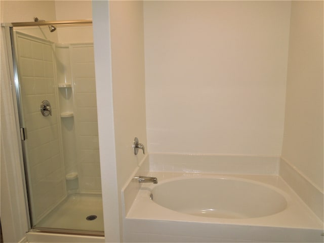 bathroom featuring separate shower and tub