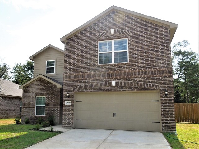 view of front property featuring a front yard and a garage