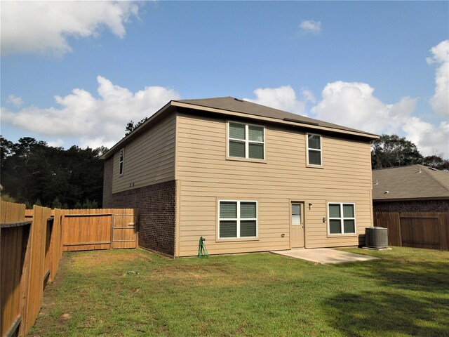 back of house with a yard, a patio area, and central AC