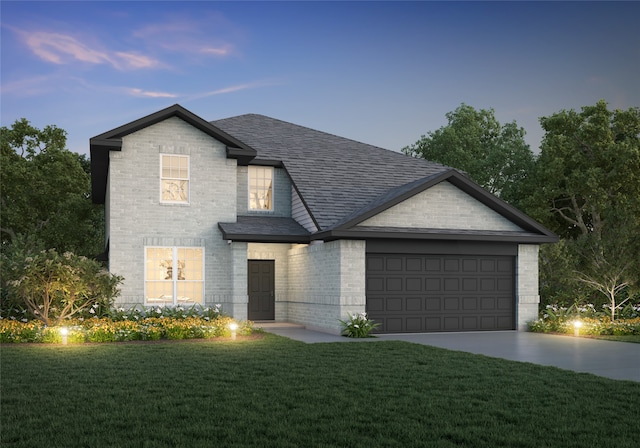 view of front of house featuring a garage and a yard