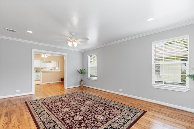 bedroom featuring ceiling fan, light wood-type flooring, and crown molding