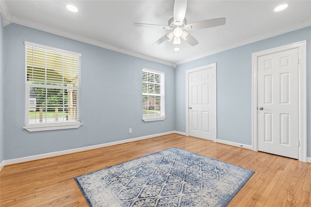 bedroom featuring multiple windows, ornamental molding, light hardwood / wood-style flooring, and ceiling fan