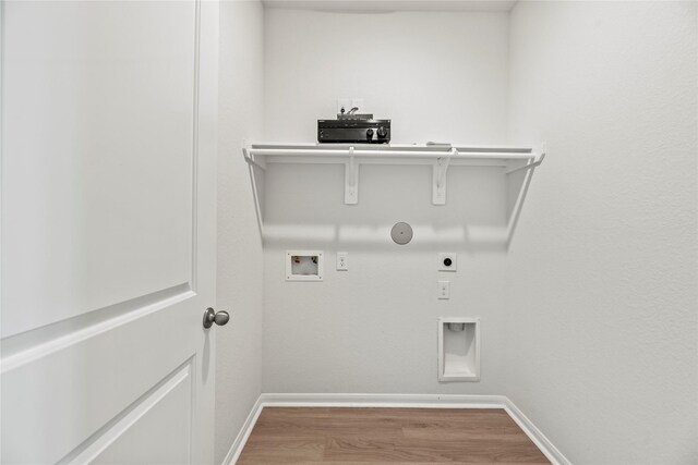 clothes washing area featuring laundry area, gas dryer hookup, wood finished floors, hookup for a washing machine, and electric dryer hookup