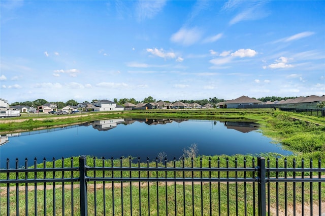 property view of water featuring fence and a residential view