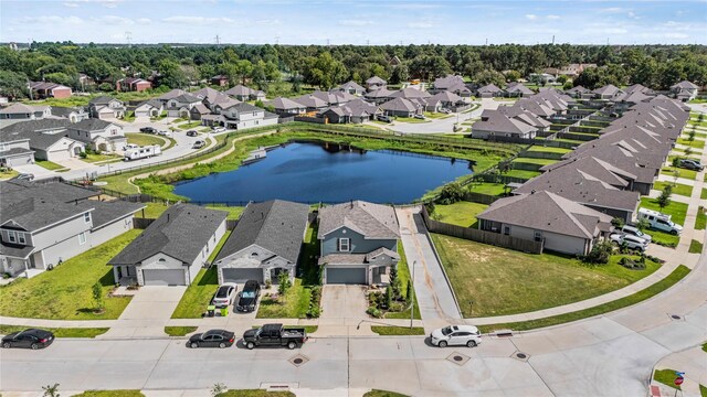 drone / aerial view with a residential view and a water view