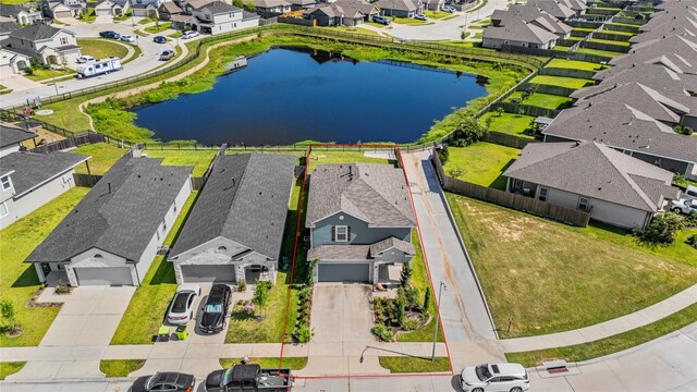 drone / aerial view with a water view and a residential view