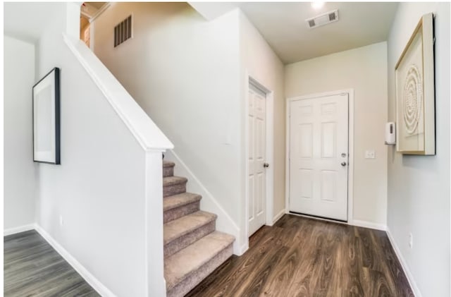 foyer entrance featuring dark hardwood / wood-style floors