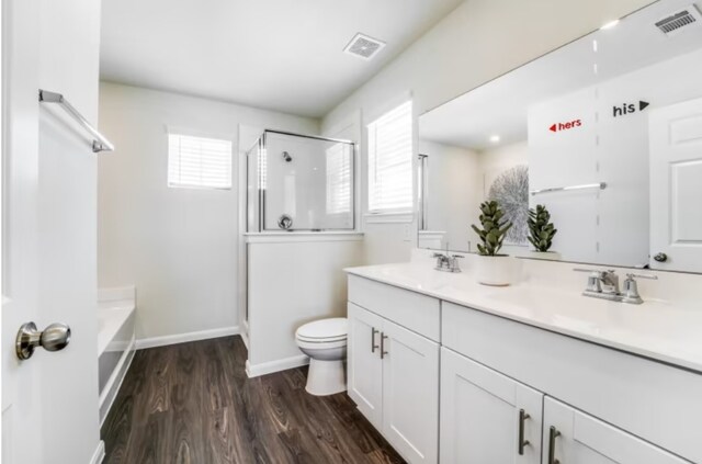 full bathroom featuring vanity, toilet, hardwood / wood-style flooring, and plus walk in shower