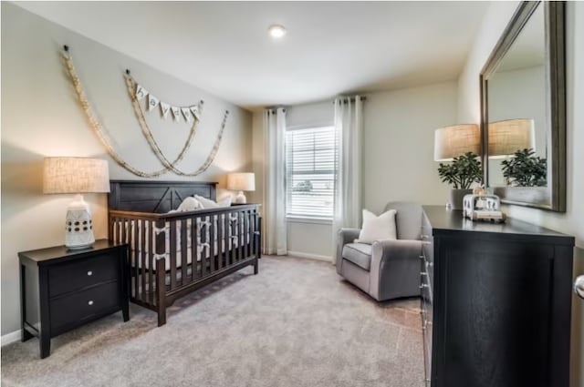 carpeted bedroom featuring a crib