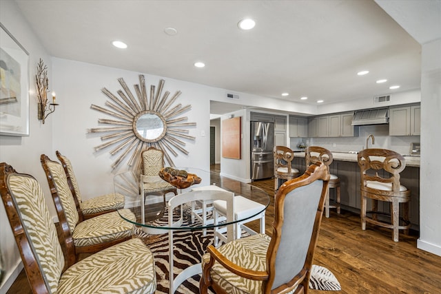 dining space featuring dark hardwood / wood-style flooring and sink