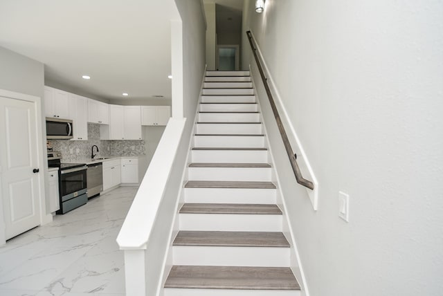 stairs with sink and tile patterned floors