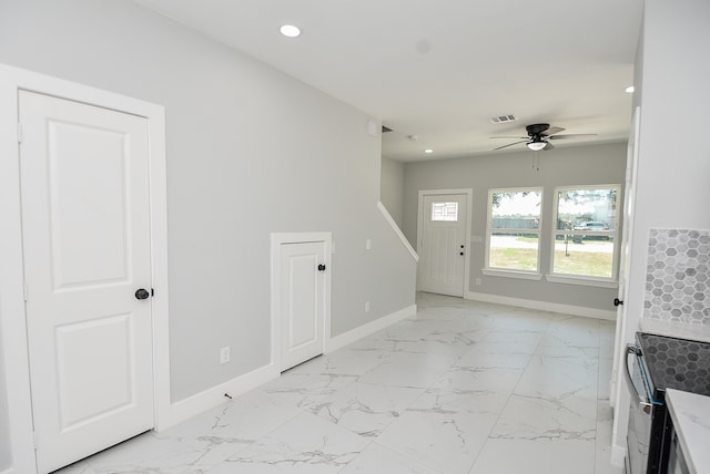 unfurnished living room with ceiling fan and light tile patterned floors