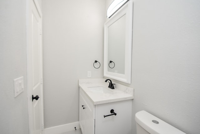 bathroom with toilet and vanity