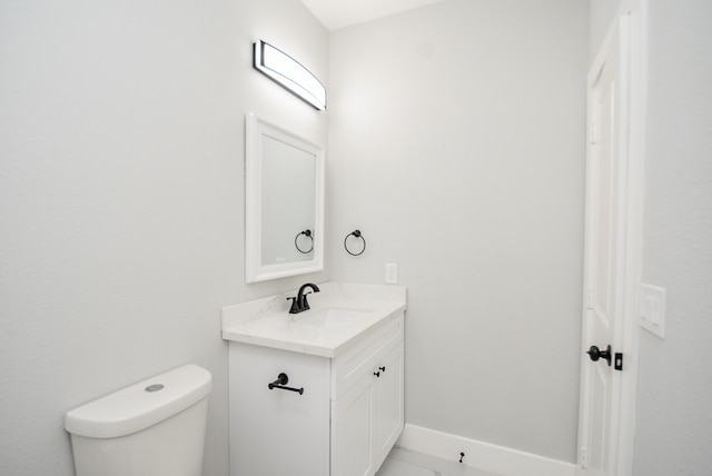 bathroom featuring toilet and vanity