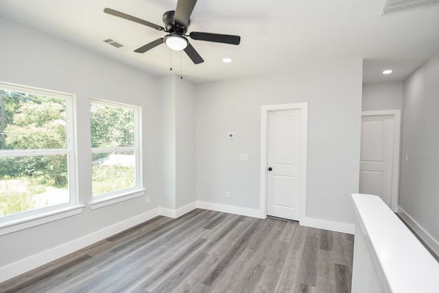 spare room with ceiling fan and wood-type flooring