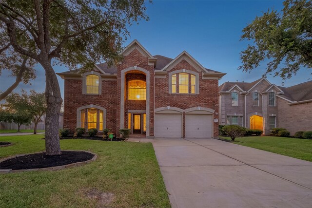 view of front of home featuring a garage and a front yard