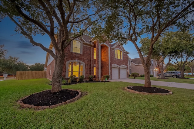 view of front of house featuring a garage and a yard